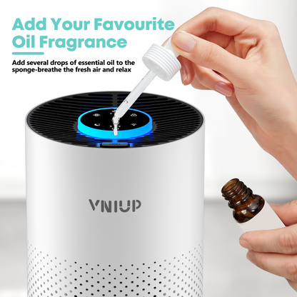 Air purifier with a hand adding essential oil using a dropper, featuring the brand 'VNIUP'.